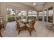 Relaxing screened porch with patio furniture and glass table at 5045 Whitestone Dr, Venice, FL 34293