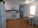 White kitchen with granite countertops and stainless steel appliances at 516 Ashwood Dr, Venice, FL 34285