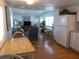 Open kitchen with white cabinets, light wood floors, and view of living room at 516 Ashwood Dr, Venice, FL 34285