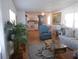 Bright living room with hardwood floors, comfortable seating, and open view to the kitchen at 516 Ashwood Dr, Venice, FL 34285
