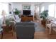 Spacious living room with hardwood floors, comfortable seating, and a large flat-screen TV at 516 Ashwood Dr, Venice, FL 34285
