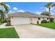 Single-story home with attached garage and landscaped lawn at 538 Laurel Cherry Ln, Venice, FL 34293