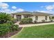 Well-maintained house with a landscaped lawn and walkway at 538 Laurel Cherry Ln, Venice, FL 34293