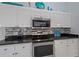 Modern kitchen featuring stainless steel appliances and mosaic backsplash at 538 Laurel Cherry Ln, Venice, FL 34293