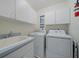Well-lit laundry room, complete with washer and dryer at 538 Laurel Cherry Ln, Venice, FL 34293