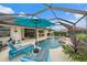 Relaxing pool area with a screened enclosure and lounge chairs at 538 Laurel Cherry Ln, Venice, FL 34293