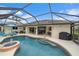 Inviting pool with a screened enclosure, fountain, and patio furniture at 538 Laurel Cherry Ln, Venice, FL 34293