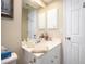 Clean bathroom with white vanity, mirror, and towel at 5800 Sabal Trace Dr # 701, North Port, FL 34287