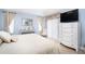 Relaxing bedroom with a king-size bed, dresser, and sliding glass door at 5800 Sabal Trace Dr # 701, North Port, FL 34287