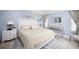 Main bedroom with a king-size bed and light, airy decor at 5800 Sabal Trace Dr # 701, North Port, FL 34287