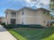 Exterior shot of a condo building with lush green lawns and well-maintained landscaping at 5800 Sabal Trace Dr # 701, North Port, FL 34287