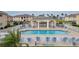 Community pool with patio furniture and pergola at 5800 Sabal Trace Dr # 701, North Port, FL 34287