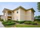 Attractive condo building featuring a two-story design and manicured grounds at 5800 Sabal Trace Dr # 701, North Port, FL 34287