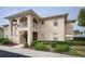 Charming two-story condo featuring stucco siding, arched entryways, and well-maintained landscaping at 5800 Sabal Trace Dr # 701, North Port, FL 34287