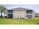 Two-story building with screened balconies and lawn at 5800 Sabal Trace Dr # 701, North Port, FL 34287