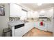 Updated kitchen features white cabinetry, granite countertops, and tile backsplash at 5800 Sabal Trace Dr # 701, North Port, FL 34287