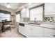 Bright kitchen boasts white cabinets, granite counters, and a breakfast nook at 5800 Sabal Trace Dr # 701, North Port, FL 34287