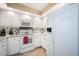 Modern kitchen with white appliances, granite countertops, and ample cabinet space at 5800 Sabal Trace Dr # 701, North Port, FL 34287