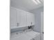 Laundry room with washer, dryer, and upper cabinets at 640 Back Nine Dr, Venice, FL 34285