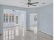 Light blue living room with tile floors and ceiling fan at 640 Back Nine Dr, Venice, FL 34285