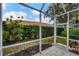 Screened patio with tile floor and view of backyard at 640 Back Nine Dr, Venice, FL 34285