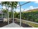 Screened patio with tile floor and view of backyard at 640 Back Nine Dr, Venice, FL 34285