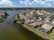 Aerial view of a lakefront community with numerous houses at 651 Lakescene Dr, Venice, FL 34293