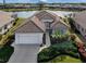 Single-story home with tile roof and landscaped yard at 651 Lakescene Dr, Venice, FL 34293