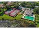 Aerial view of tennis courts, pool, and clubhouse at 651 Lakescene Dr, Venice, FL 34293
