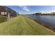 Lakefront property showcasing a large backyard and screened patio at 651 Lakescene Dr, Venice, FL 34293