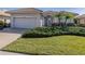 Charming house with a two-car garage and manicured lawn at 651 Lakescene Dr, Venice, FL 34293