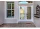 Inviting house entrance featuring a double door with glass inserts and a decorative wall accent at 651 Lakescene Dr, Venice, FL 34293