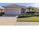 Single-story house with attached garage and manicured lawn at 651 Lakescene Dr, Venice, FL 34293