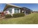 Back exterior of house with screened-in patio at 651 Lakescene Dr, Venice, FL 34293