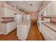 Kitchen with island, hardwood floors, and white cabinets at 651 Lakescene Dr, Venice, FL 34293