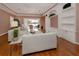 Bright living room with built-in shelving and hardwood floors at 651 Lakescene Dr, Venice, FL 34293