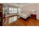 Main bedroom with hardwood floors, large window, and built-in window seat at 651 Lakescene Dr, Venice, FL 34293