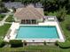 Community pool with lounge chairs and clubhouse at 651 Lakescene Dr, Venice, FL 34293