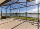 Spacious screened patio overlooking a lake, perfect for outdoor relaxation at 651 Lakescene Dr, Venice, FL 34293