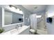 Updated bathroom with modern vanity, tub, and shower at 664 Linden Dr, Englewood, FL 34223