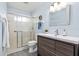 Clean bathroom with modern vanity, updated shower, and new flooring at 664 Linden Dr, Englewood, FL 34223