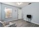 Bright bedroom with light walls, armchair, and window view at 664 Linden Dr, Englewood, FL 34223