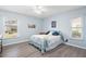 Bright bedroom with light blue walls, new flooring, and plenty of natural light at 664 Linden Dr, Englewood, FL 34223