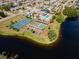 Aerial view of community pool, tennis court, and shuffleboard at 664 Linden Dr, Englewood, FL 34223