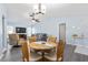 Light and airy dining area with wood table and four chairs at 664 Linden Dr, Englewood, FL 34223