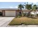 Cute two-bedroom villa with attached garage and landscaped yard at 664 Linden Dr, Englewood, FL 34223
