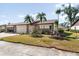 Attractive single story home with two-car garage and lush landscaping at 664 Linden Dr, Englewood, FL 34223