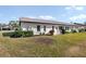 Rear view of house showcasing a patio and well-maintained lawn at 664 Linden Dr, Englewood, FL 34223