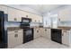 Updated kitchen with granite countertops and black appliances at 664 Linden Dr, Englewood, FL 34223