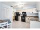 Kitchen with granite countertops and black appliances at 664 Linden Dr, Englewood, FL 34223